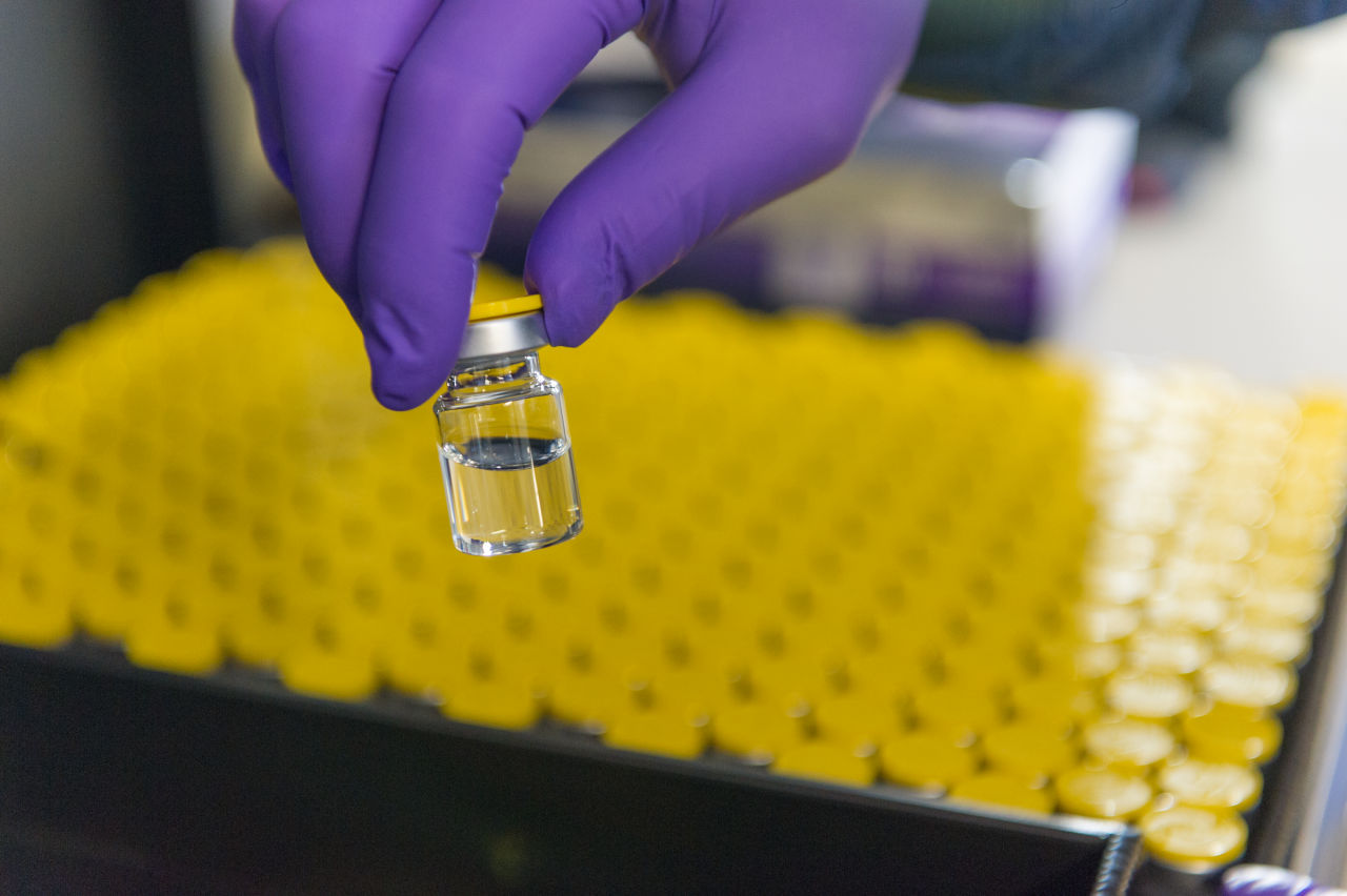 Hand holding vial