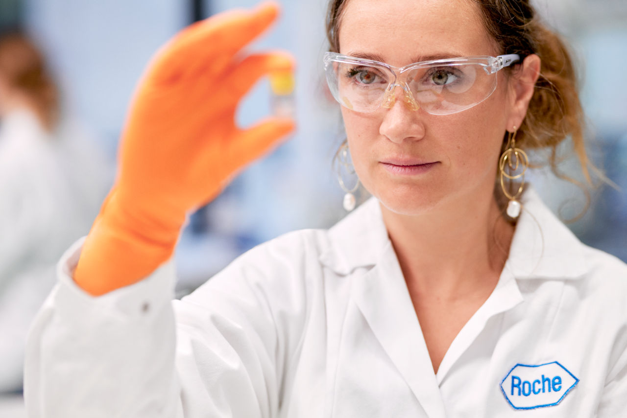 Woman in lab holding vial