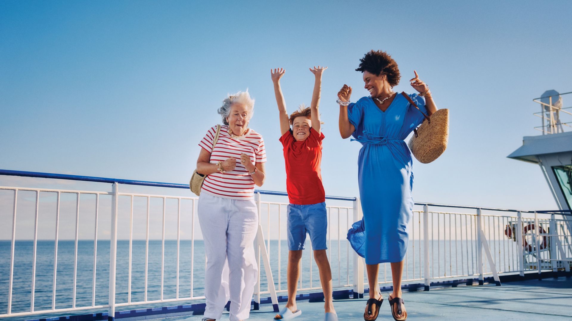 Three generations enjoying time together on board a Stena Line ferry under clear blue skies