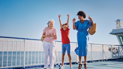 Three generations enjoying time together on board a Stena Line ferry under clear blue skies