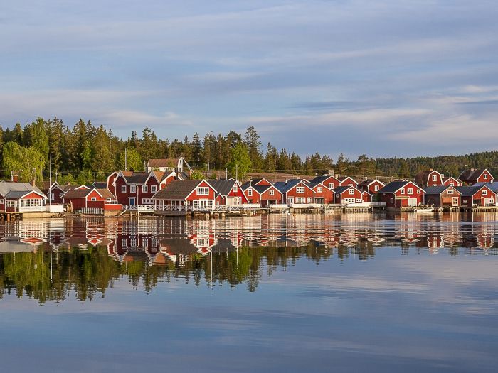 red houses at sunset in the  fishing village of Norfaellsviken, Höga Kusten, Sweden