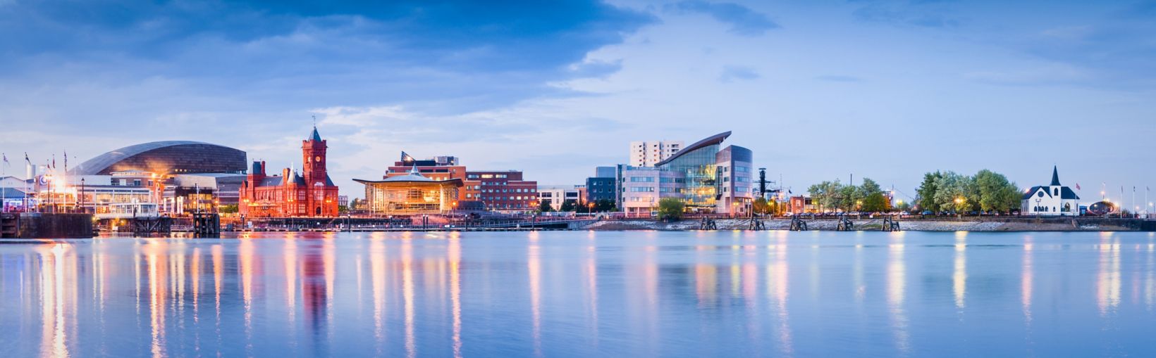 Pretty night time illuminations of the stunning Cardiff Bay, many sights visible including the Pierhead building (1897) and National Assembly for Wales.