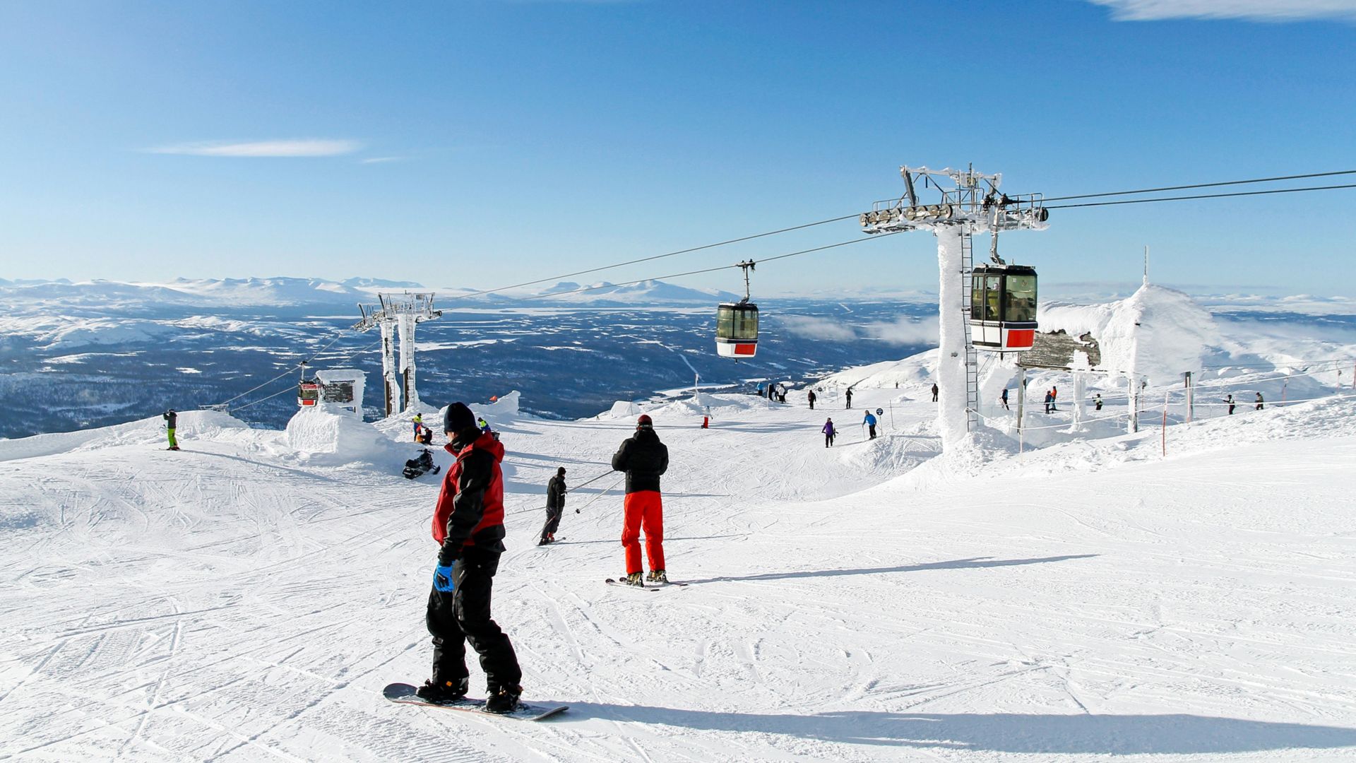 Skiers on the top of a piste