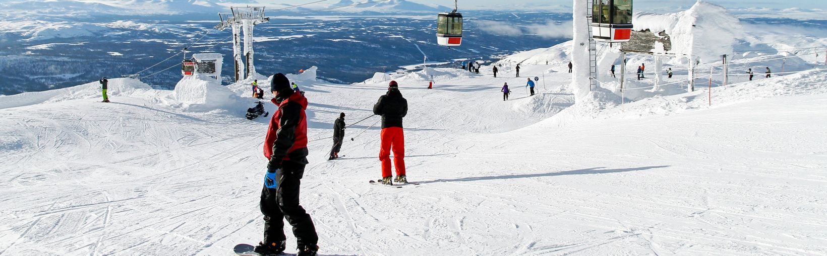 Skiers on the top of a piste