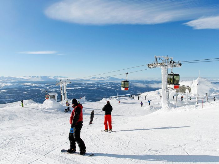 Skiers on the top of a piste