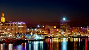 Kiel waterfront lit-up at night and reflected in the harbour