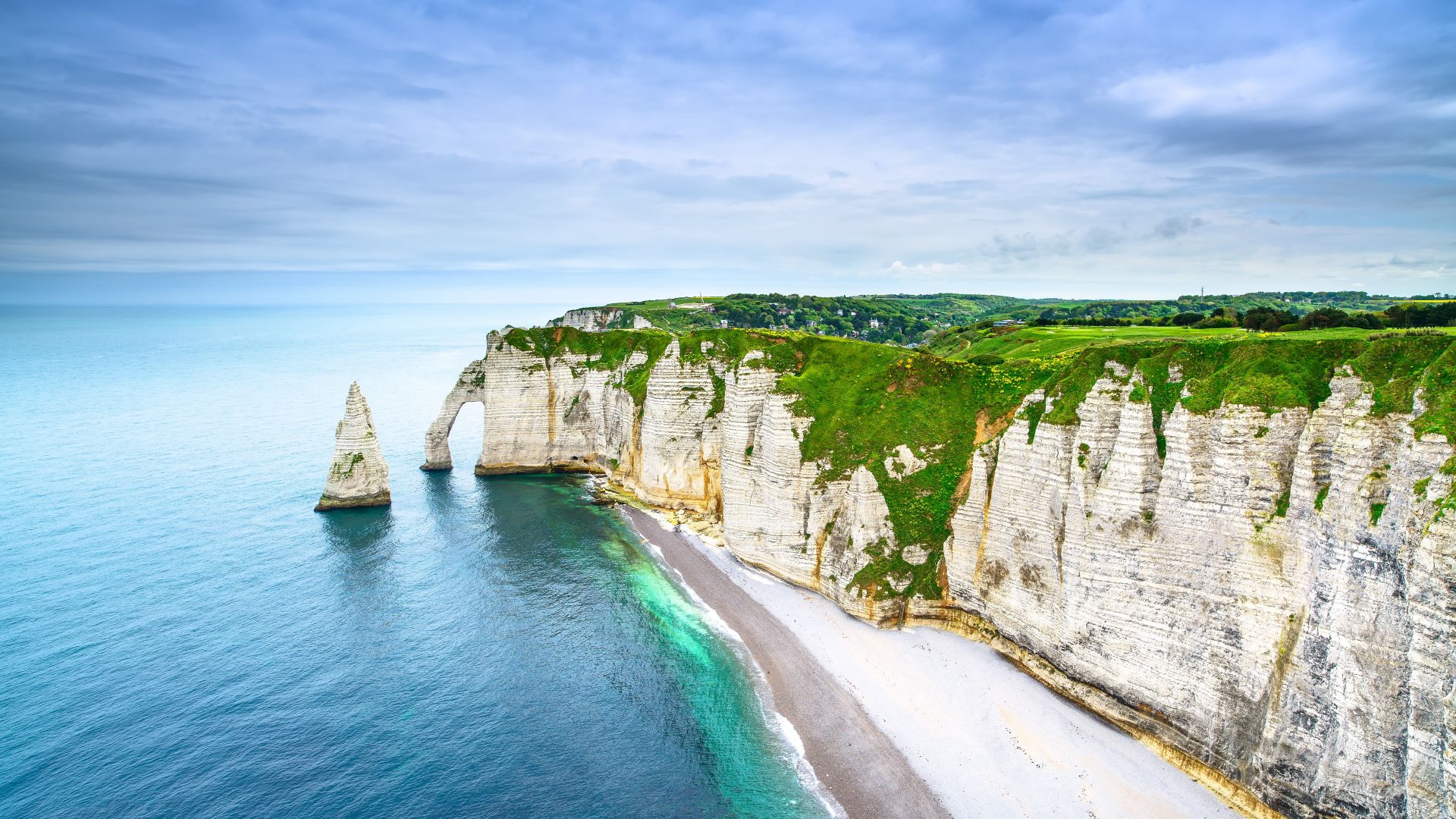 Etretat Aval cliff, rocks and natural arch landmark and blue ocean. Aerial view. Normandy, France, Europe.