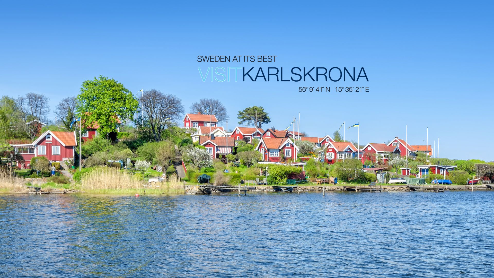 Panorama of traditional buildings with red walls and roofs on the coast of Karlskrona at Brandaholm peninsula