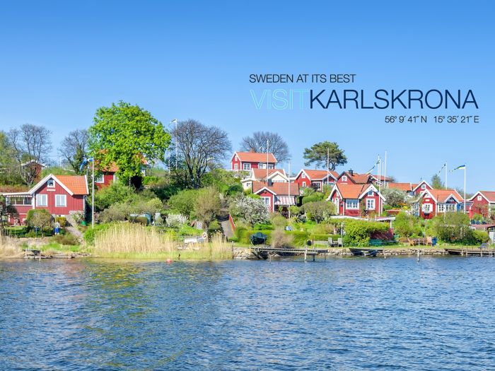 Panorama of traditional buildings with red walls and roofs on the coast of Karlskrona at Brandaholm peninsula