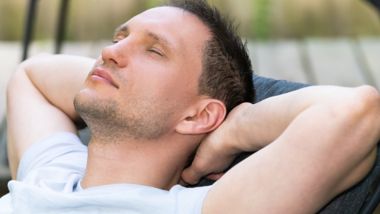 Young man relaxing in a reclining seat onboard a ferry