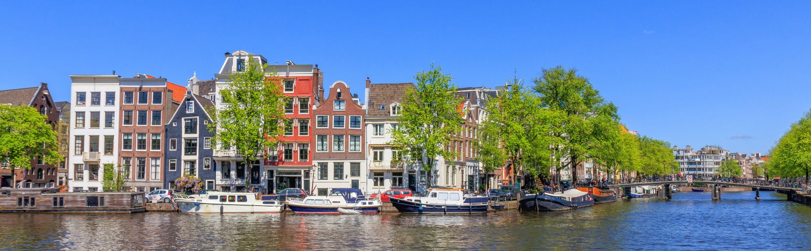 Panorama View Of Houses Near Canals In Amsterdam