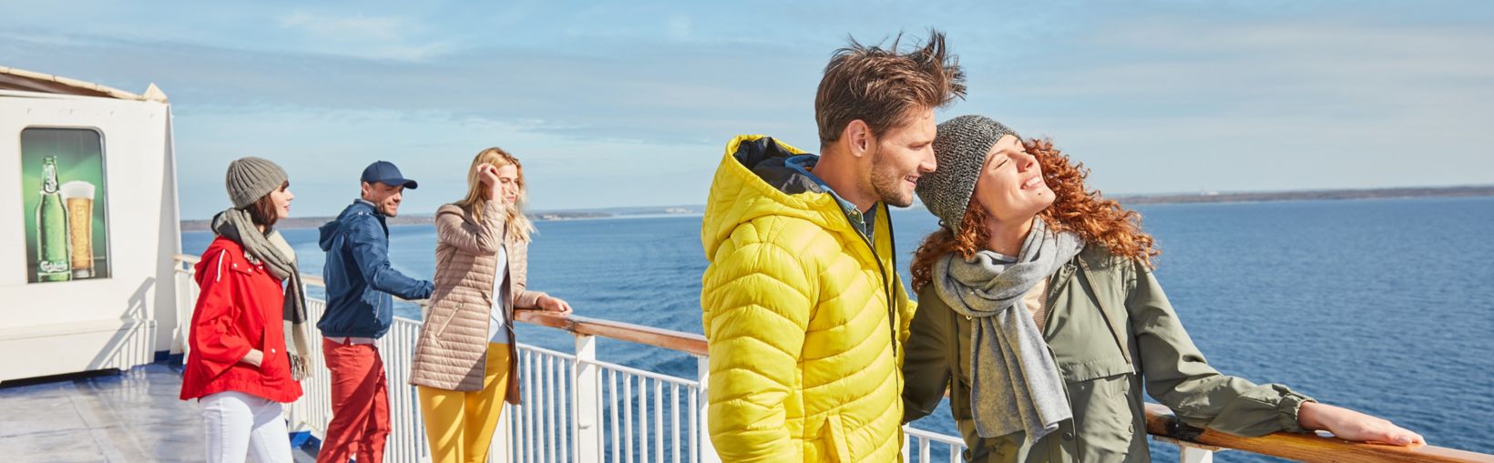 Couple on the ferry deck wind horizon coat