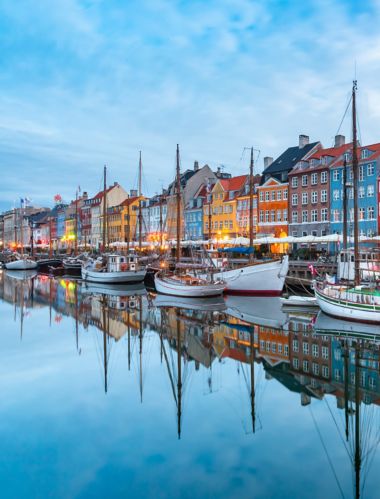 Nyhavn with colorful facades of old houses and old ships in the Old Town of Copenhagen, capital of Denmark.