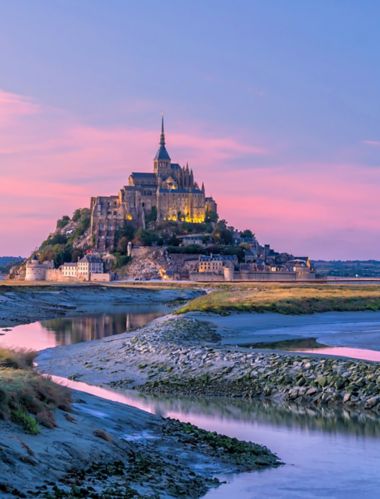 Mont Saint-Michel at sunset twilight in Normandy, northern France
