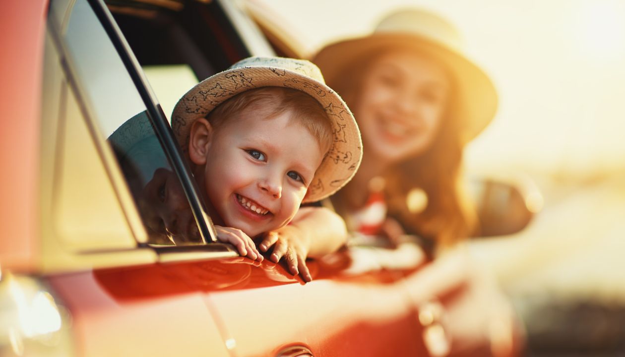 happy  family mother and child boy goes to summer travel trip in the car
