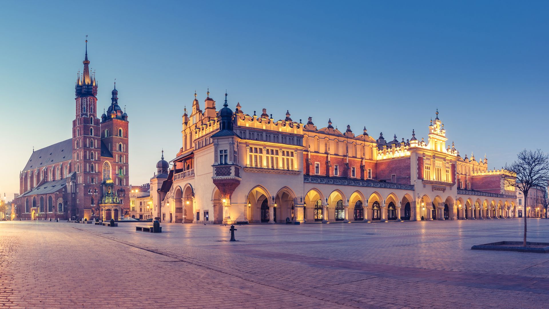 Krakow, Poland, main square night panorama with Cloth Hall and St Mary's church