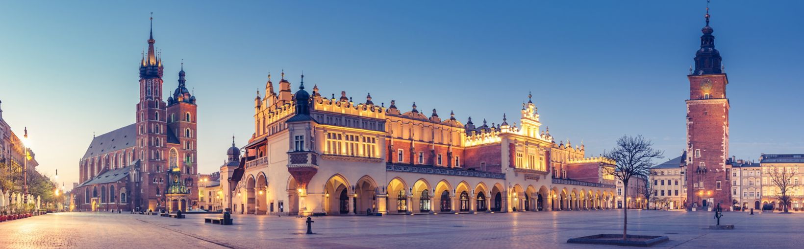 Krakow, Poland, main square night panorama with Cloth Hall and St Mary's church