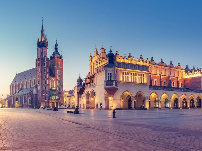 Krakow, Poland, main square night panorama with Cloth Hall and St Mary's church