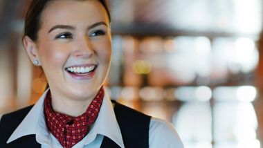 A smiling female Stena Line staff member onboard