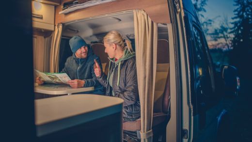 Couples and the RV Park Camping. Young Couples Planning Next Trip in the Motorhome.