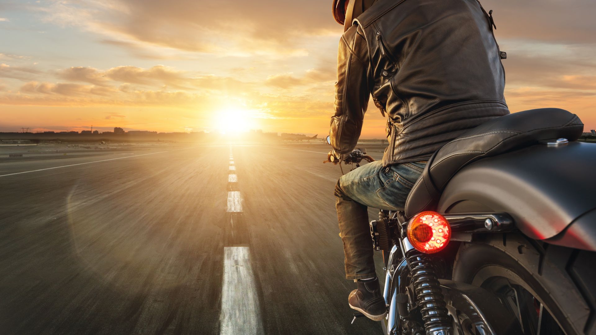 Motorcycle driver riding alone on asphalt motorway. Outdoor photography. Travel and sport, speed and freedom concept