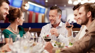 Groups of friends enjoying a meal in the a la carte restaurant onboard