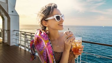 Woman enjoying a drink outside in the Deck Bar