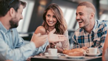 Group of friends enjoying coffee and snacks onboard