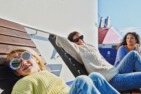 Friends and kid on open deck