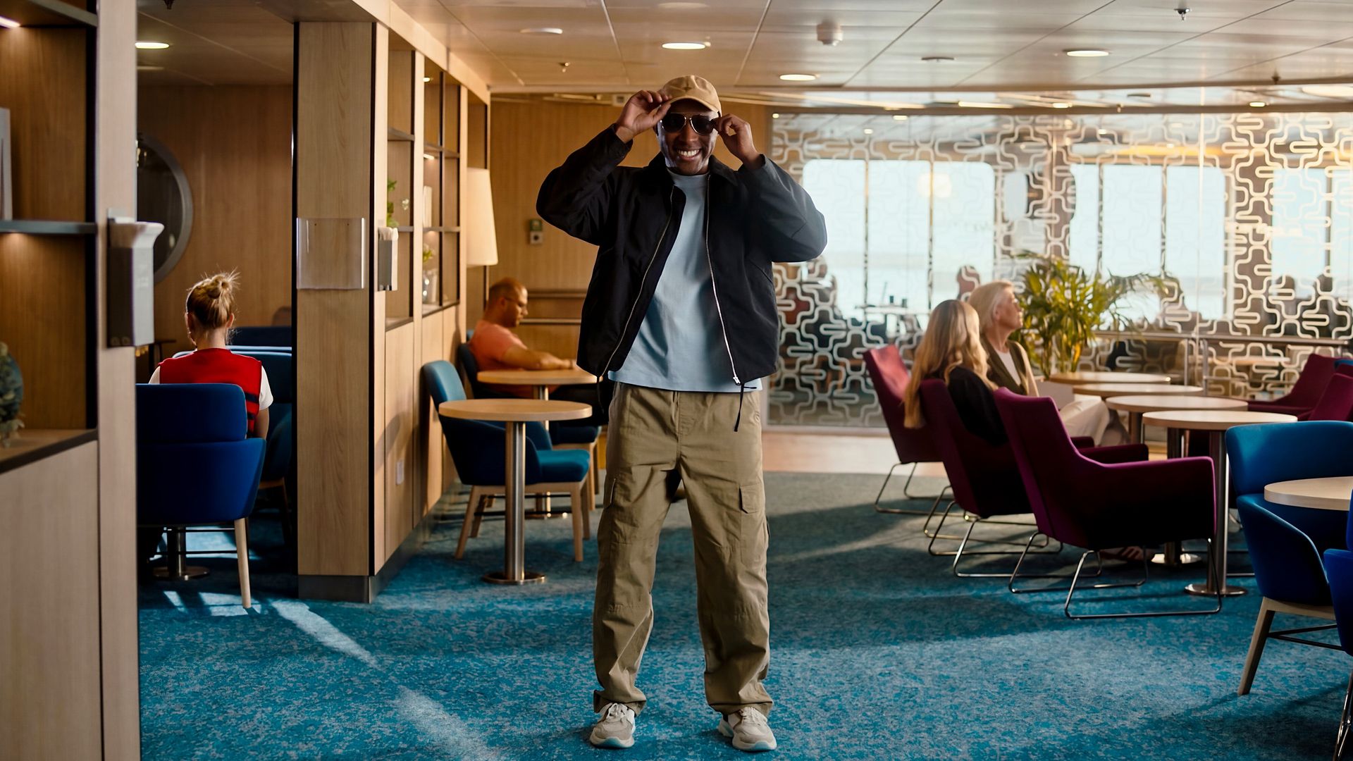 Modern lounge onboard Stena Line ferry, guest relaxing in stylish seating area supporting comfortable sea travel experience