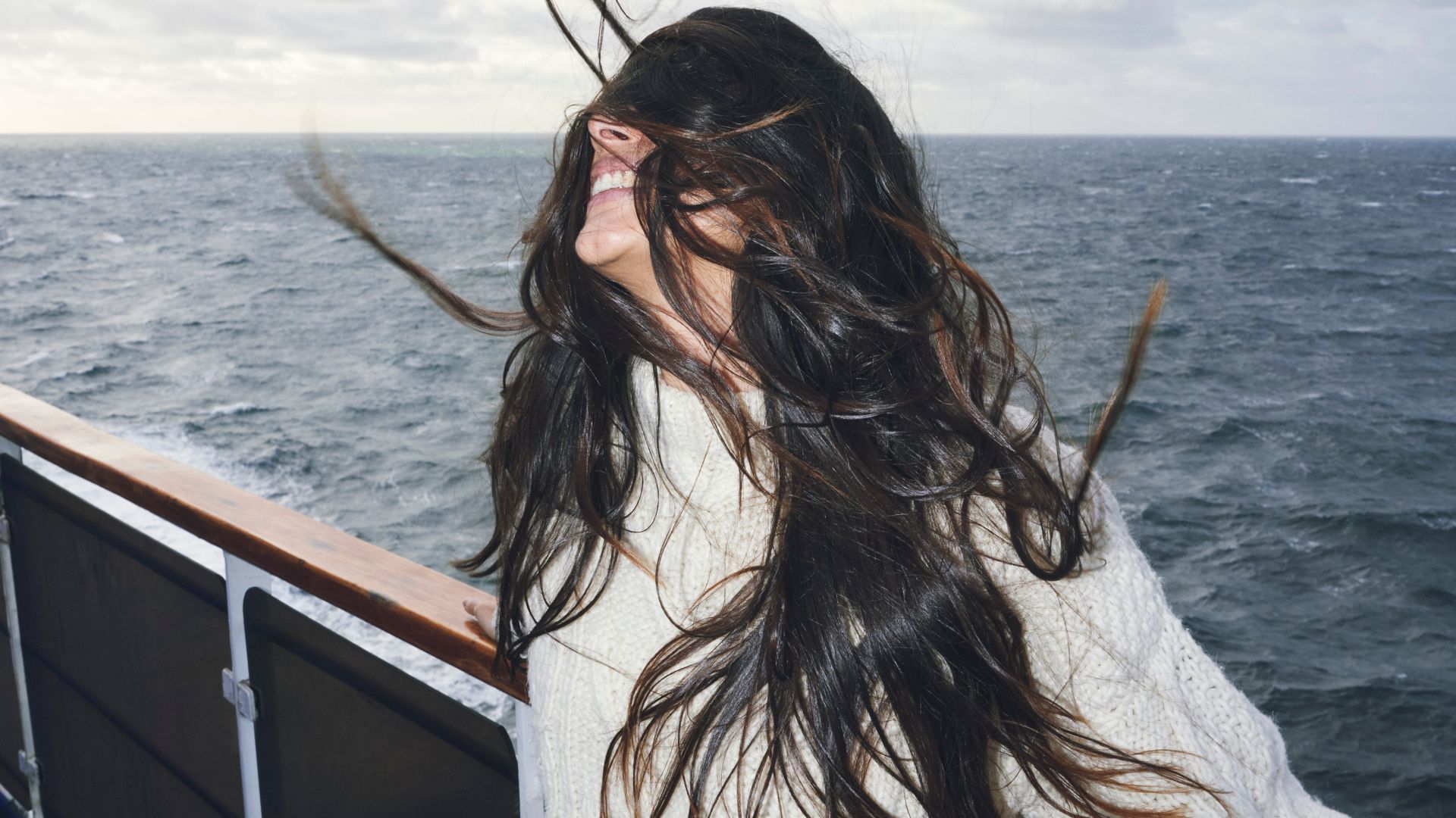 Solo woman on deck, wind on her face