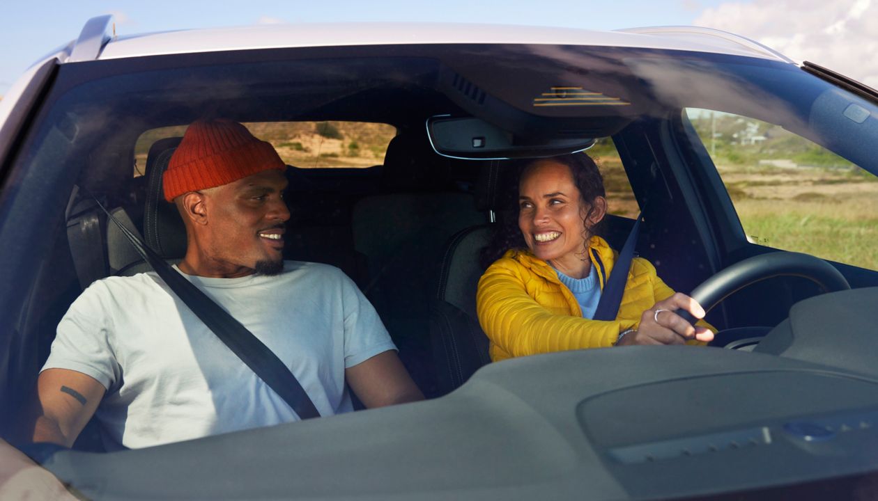 Couple travelling by car during autumn