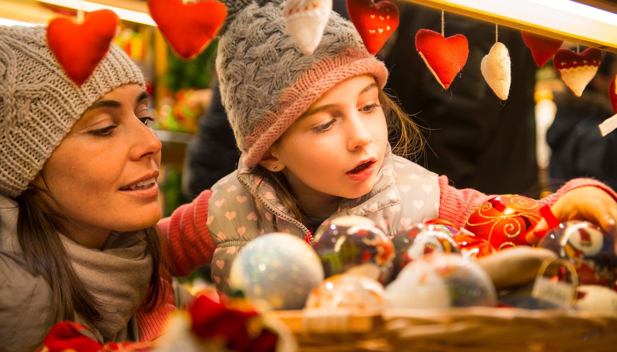 mother and daughter selecting decoration on a Christmas market