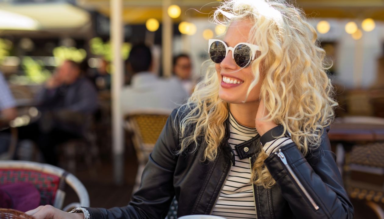 Happy and carefree woman sitting at cafe