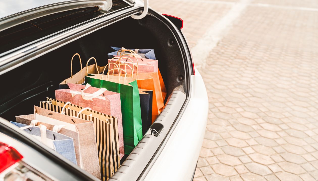 Shopping bags in car trunk or hatchback, with copy space. Modern shopping lifestyle, rich people or leisure activity concept