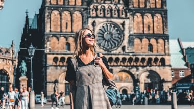 Young girl on central square of Bremen near Catherdral. Germany 