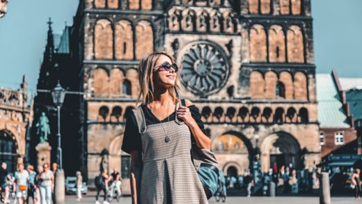 Young girl on central square of Bremen near Catherdral. Germany 
