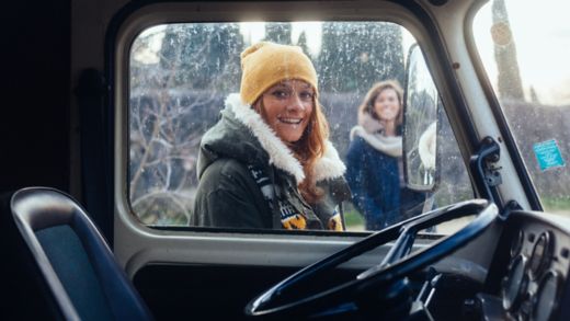 Portrait of two women traveling in Italy with a van during the cold season