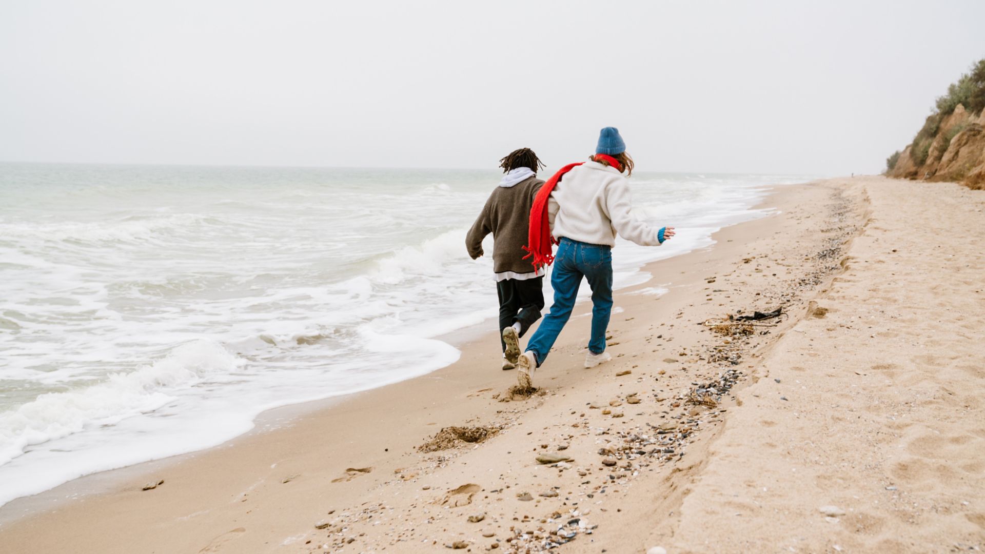 Young couple walking at the beachside