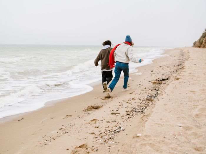 Young couple walking at the beachside