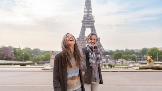 Happy mature couple in front of Eiffel Tower, Paris, France