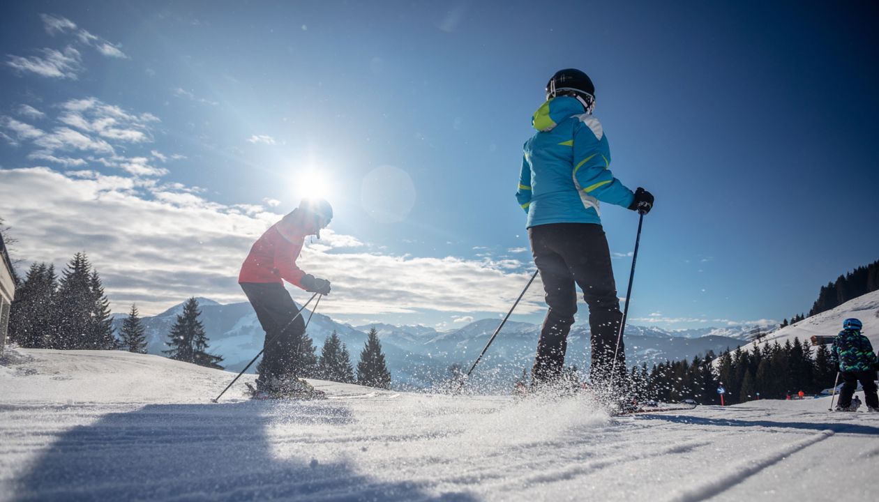 man and woman skiing and snowboarding in the mountains, ski resort