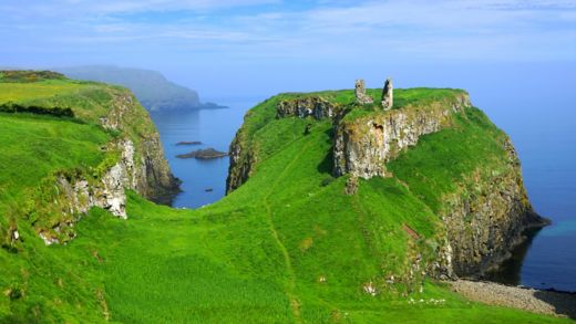 Ruins of the ancient Dunseverick Castle atop the green cliffs of the Causeway Coast, Northern Ireland