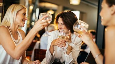 Group of businesswoman having wine in a cafe bar after work