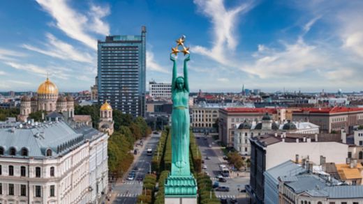 Beautiful sunrise view over Riga by the statue of liberty - Milda in Latvia. The monument of freedom.