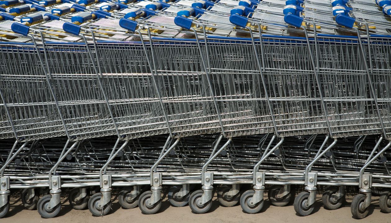 A lot of blue trolleys standing together