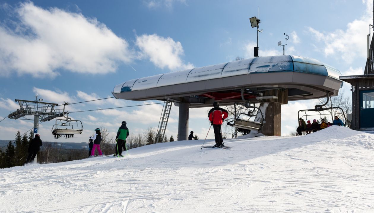 ISABERG, SWEDEN - FEBRUARY 17, 2016: Top station of modern chair lift at the small ski resort Isaberg in Sweden welcomes skiers on a sunny day during the main skiing season in February.