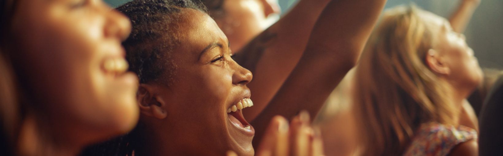 Young girls in an audience enjoying their favourite bands performance