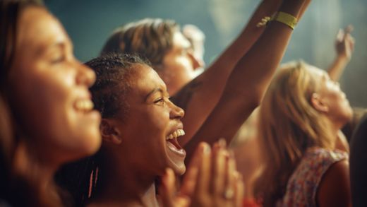 Young girls in an audience enjoying their favourite bands performance