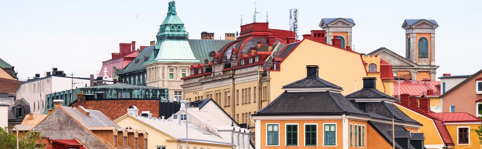 Colourful historic buildings in central Karlskrona with ornate rooftops and classical architecture.